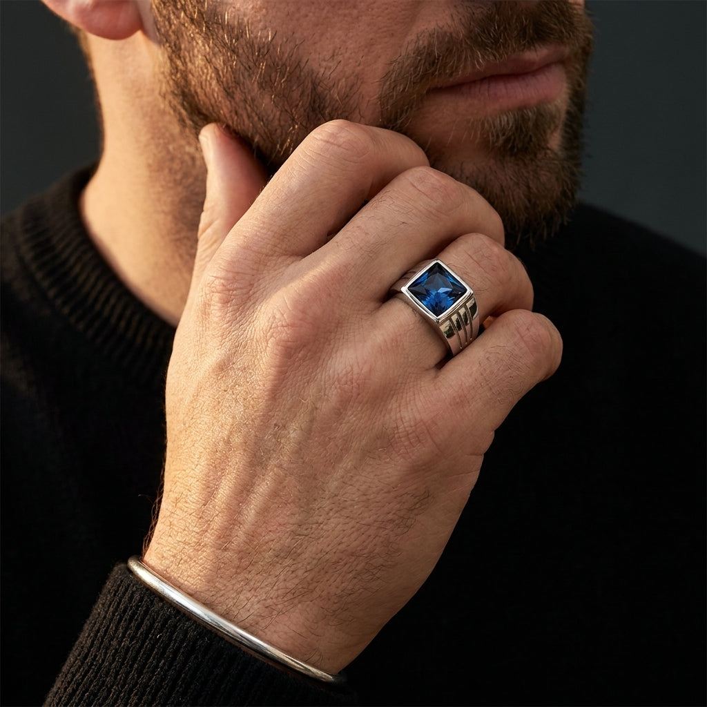Chevalière pierre bleue argent, portée, main contre le visage